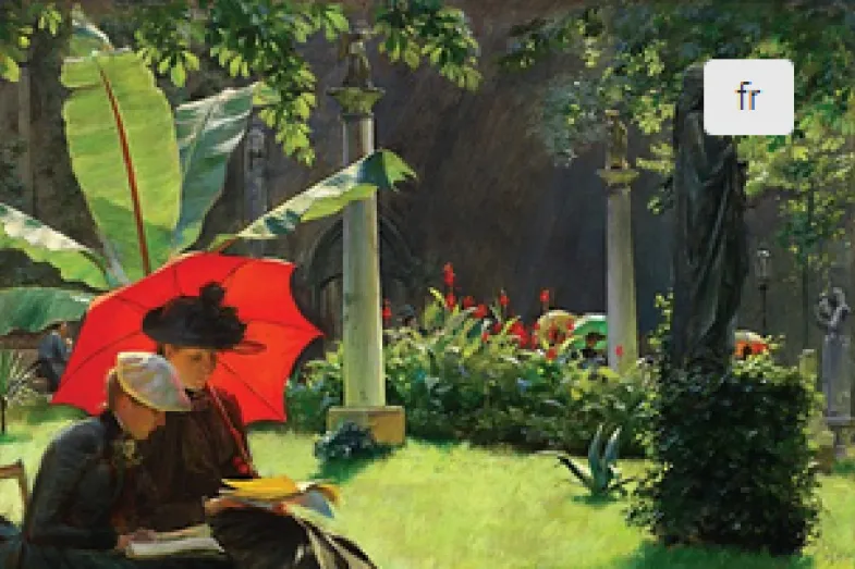Photographie di jardin botanique vert avec au premier plan deux personnes assises sous une ombrelle rouge